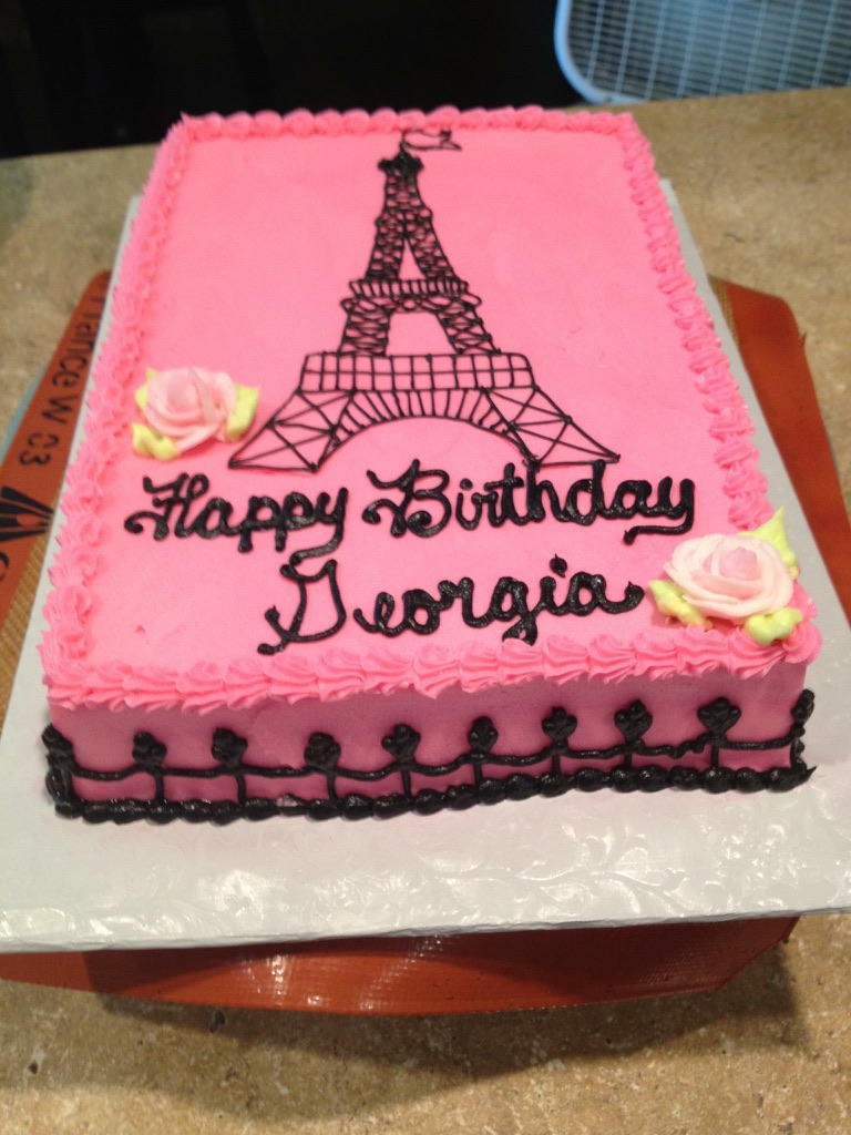 Pink sheet cake with a piped Eiffel Tower and sugar roses