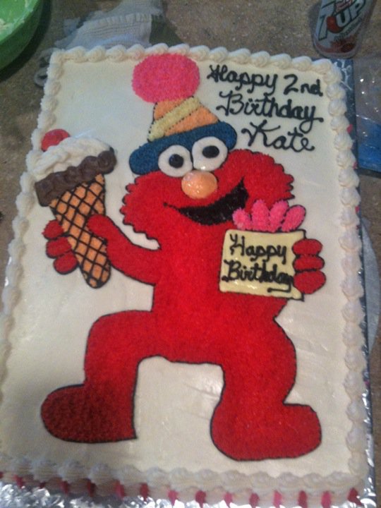 Sheet cake with a hand-piped Elmo holding an ice cream cone