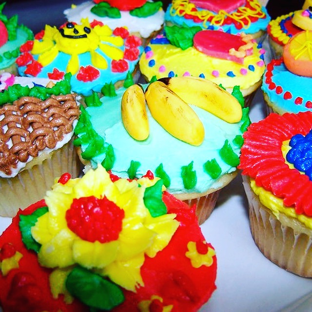 Brightly decorated fiesta cupcakes with piped flowers and fruit
